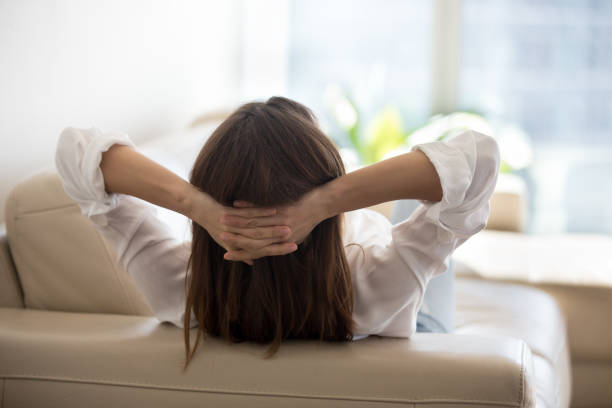 istock Female relaxing at home lying on cozy sofa 1032230942