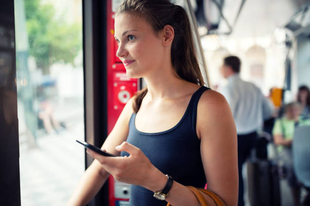 istock Young woman with mobile goes by train 1032232546
