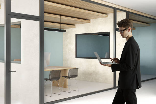 istock Handsome businessman using laptop in office 1032244908