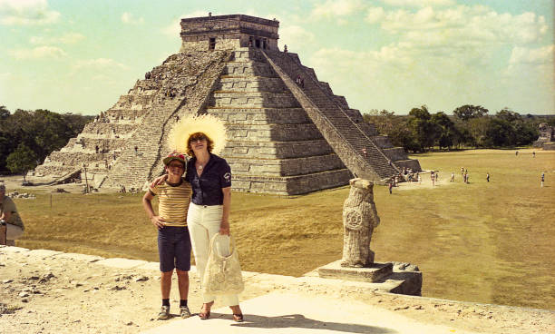 Mother and son against El Castillo/Kukulkan Pyramid Vintage image a mother andher son against the El Castillo/Kukulkan Pyramid in Chichen Itza, Mexico. yucatan photos stock pictures, royalty-free photos & images