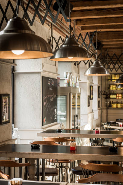 istock Ceiling lamps and tables in pizzeria 1032256388