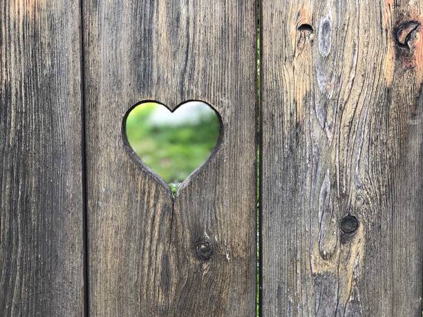 istock Heart shaped hole in wooden door 1032260810