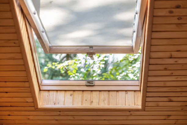 Opened roof window with blinds or curtain in wooden house attic. Room with slanted ceiling made of natural eco materials and park view through opened window. Environment friendly house Opened roof window with blinds or curtain in wooden house attic. Room with slanted ceiling made of natural eco materials and park view through opened window. Environment friendly house. skylight stock pictures, royalty-free photos & images