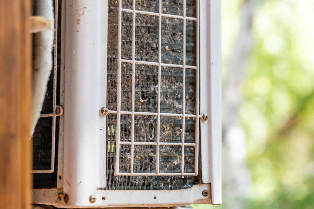 istock Close-up outdoor air condition unit with clogged obstructed compressor radiator grill. Details of air conditioner needed to clean and maintenance. House climate system check up and service 1032271092