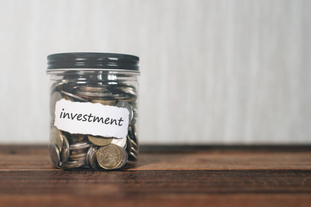 istock Close-Up Of Coins In Jar On Table 1032277536