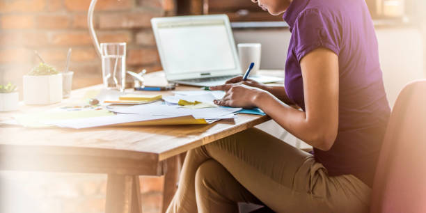 istock Young woman working late 1032295144