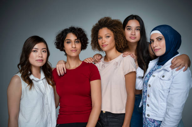 Portrait of a Group of women in the studio. Portrait of a Group of women in the studio. Multi-ethnic group including Caucasian, Hispanic, middle eastern, Asian and African American. One middle eastern woman is wearing a hijab womens issues photos stock pictures, royalty-free photos & images