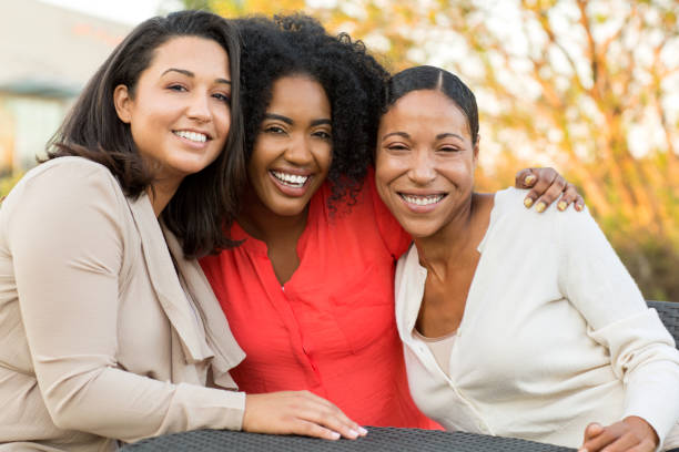 Multi-ethnic group of women laughing and talking. stock photo