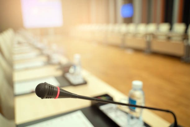 istock Microphone over the blurred business forum Meeting or Conference Training Learning Coaching Room Concept, Blurred background. 1032344166