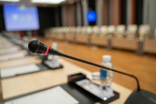 istock Microphone over the blurred business forum Meeting or Conference Training Learning Coaching Room Concept, Blurred background. 1032344174