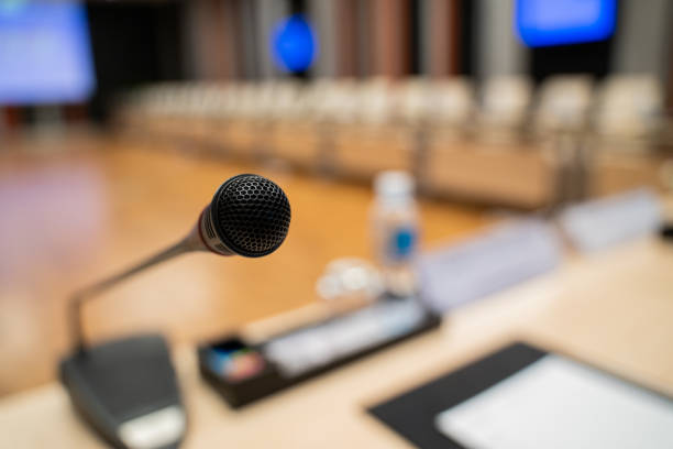 istock Microphone over the blurred business forum Meeting or Conference Training Learning Coaching Room Concept, Blurred background. 1032344178