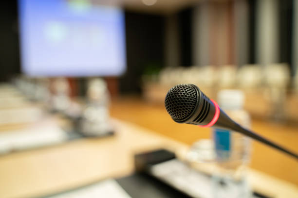 istock Microphone over the blurred business forum Meeting or Conference Training Learning Coaching Room Concept, Blurred background. 1032344192
