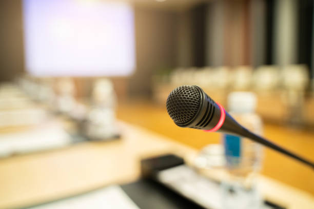 istock Microphone over the blurred business forum Meeting or Conference Training Learning Coaching Room Concept, Blurred background. 1032344204