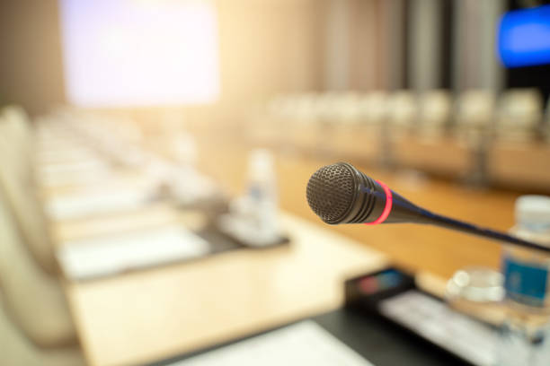 istock Microphone over the blurred business forum Meeting or Conference Training Learning Coaching Room Concept, Blurred background. 1032344206