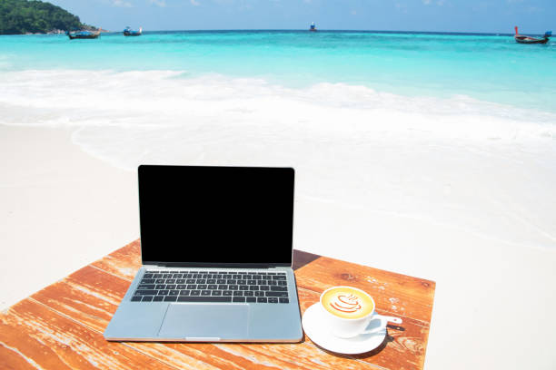 istock Laptop On The Table At The Tropical Beach 1032356838