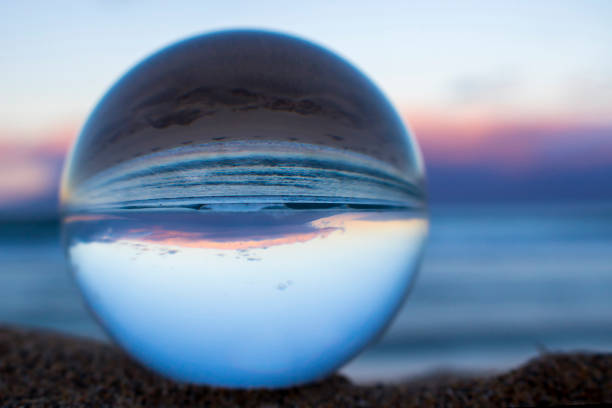 istock Sunrise over Ocean Close Up in Glass Ball 1032359062