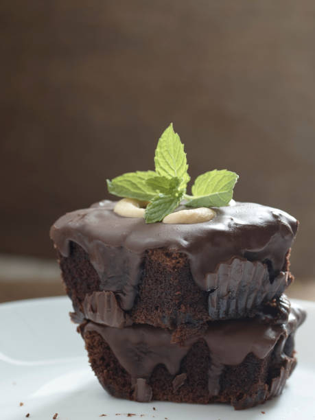 istock chocolate brownies topping with cashew nut and mint 1032371604