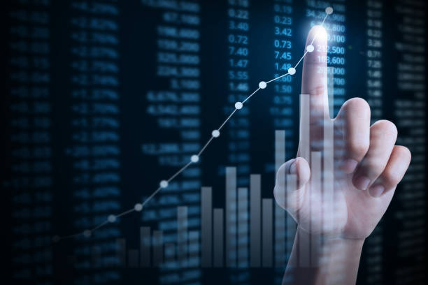 istock businessman with financial chart symbols coming from hand 1032374616