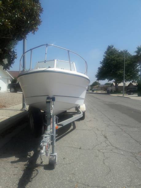 istock White boat parked on street. 1032374910