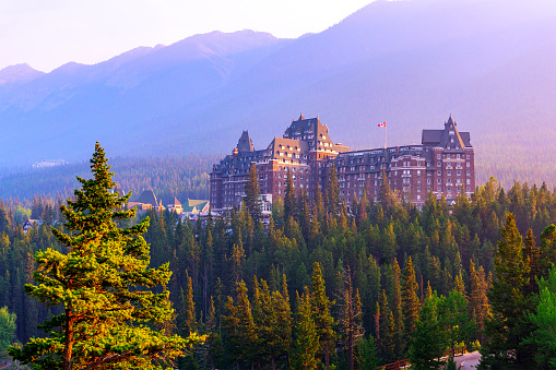 Sun setting on historic Banff Springs Hotel nestled in the Canadian Rockies of Banff National Park. Built in the 19th century, it was designated a National Historic Site by Canada in 1988.