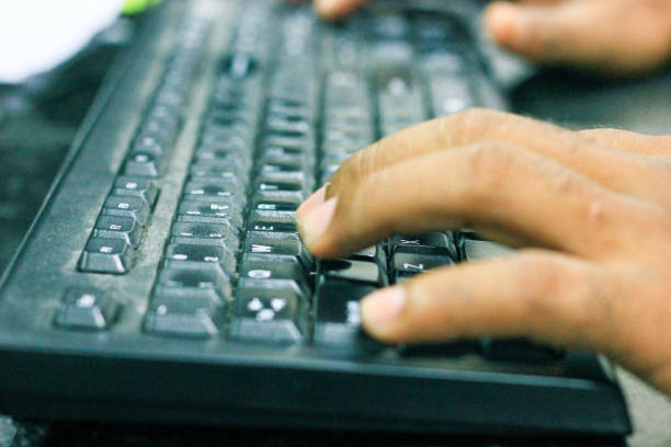 istock typist hands on black keyboard. closeup view from side 1032408118