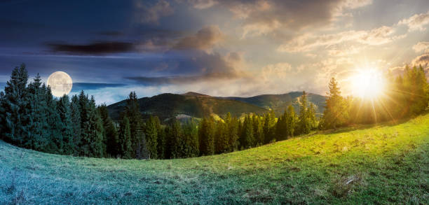 time change concept above alpine forest glade stock photo