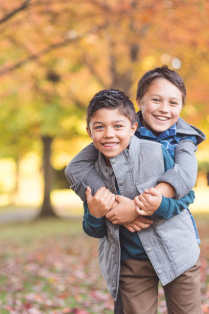 istock Two elementary-age boys walk to school through the park 1032420112