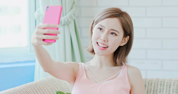 istock woman use phone selfie 1032450950