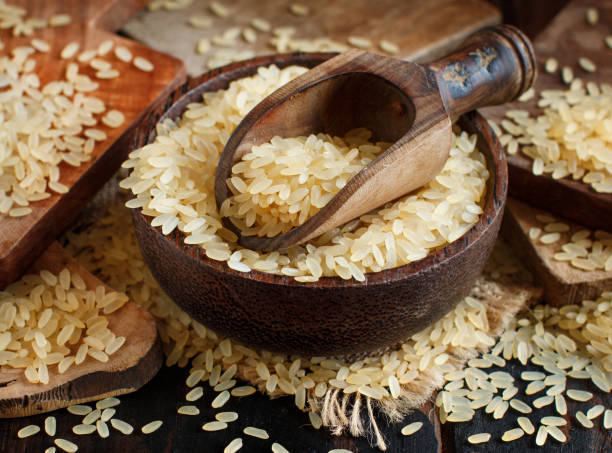 istock Parboiled rice in a bowl with a wooden spoon 1032450970