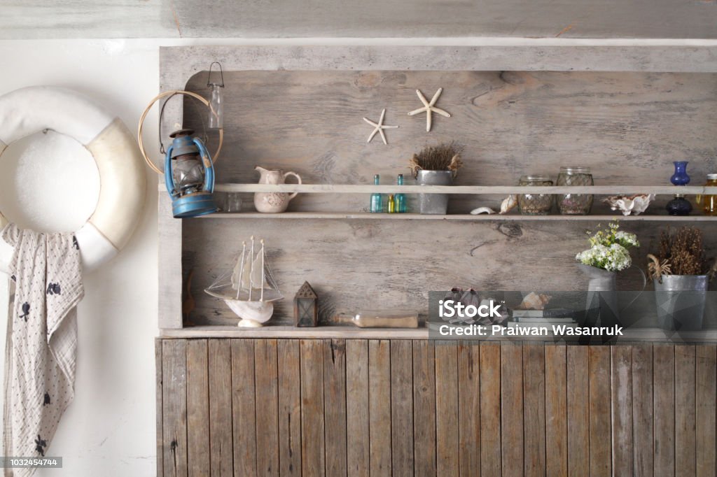 vintage wooden shelf wall in marine style the vintage wooden wall is a shelf and decorated with a lot of stuff in marine style Beach Stock Photo