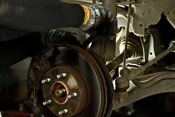 istock Technician use wrench for action to maintenance disc break car in garage. 1032454782