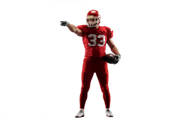 one american football player man studio isolated on white background Active one american football player isolated on white background. Fit caucasian man in uniform posing over studio background. Human emotions and facial expressions concept american football player studio stock pictures, royalty-free photos & images