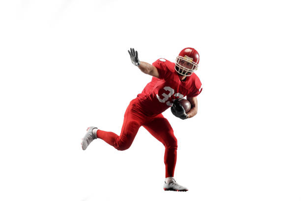 Professional american football player in action isolated on the black background