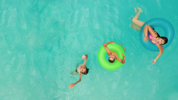 istock Kids having fun in the pool 1032458118