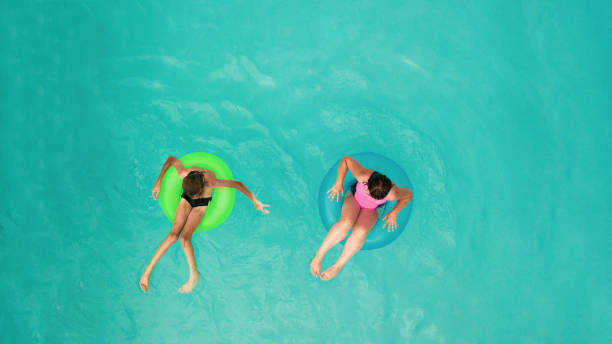 istock Children lying in inflatable rings 1032458126