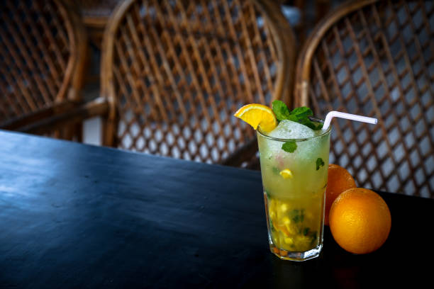 istock Lemon juice with mint along with orange on table 1032460338