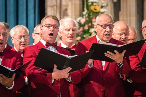 Mens choir performing in a cathedral Rochester, England -  July 2018 : Mens choir performing in a cathedral, Kent, UK anglican stock pictures, royalty-free photos & images
