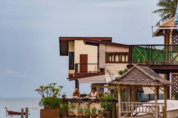 Old Town, Koh Lanta, Thailand - August 25, 2018:  Traditional over water, stilt houses in Old Town, Ko Lanta, Thailand.  Originally built from wood/bamboo and situated on the Andaman Sea, many have now been renovated into luxury homes.  These houses have stood for decades and are still occupied residentially, used for fishermen and businesses.