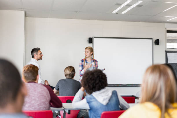 istock Female student giving presentation in classroom 1032472058