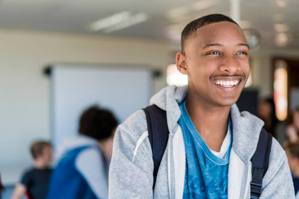 istock Happy male looking away in classroom 1032472278