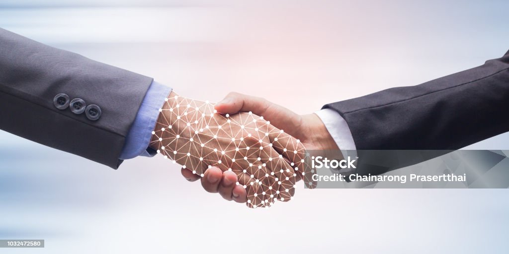 close up business man handshake with business artificial intelligence (AI) on motion blur background for future technology concept Artificial Intelligence Stock Photo