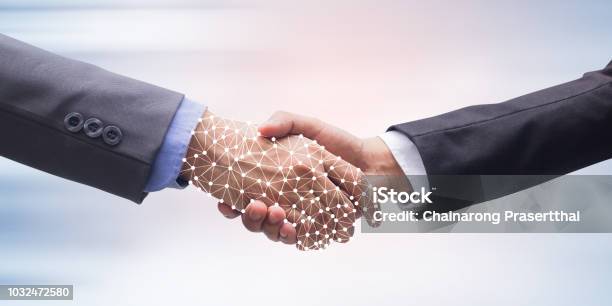 Close Up Business Man Handshake With Business Artificial Intelligence On Motion Blur Background For Future Technology Concept Stock Photo - Download Image Now