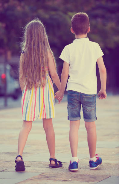 istock Two kids walking together outdoor 1032472986