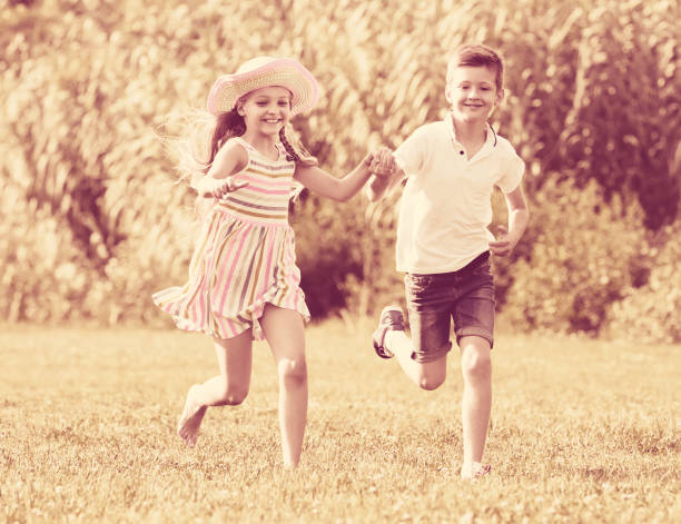 istock Two children running in park 1032473002