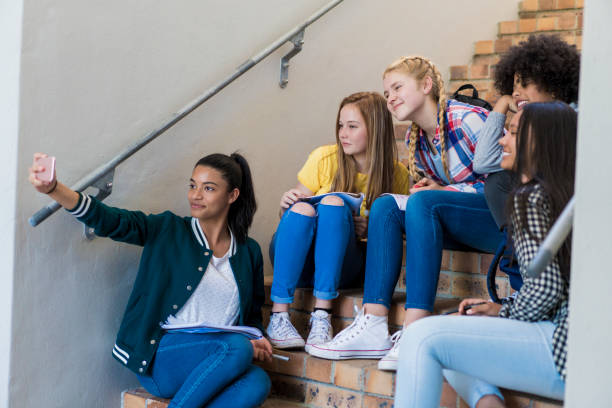 istock Female students taking selfie on steps in school 1032473368