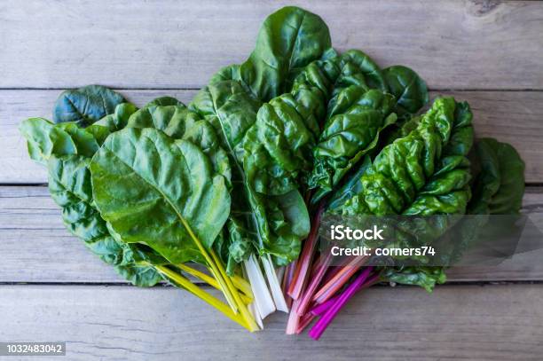 Organic Rainbow Chard Sprayfree Leafy Greens In Fan Arrangement On Rustic Wooden Background Stock Photo - Download Image Now