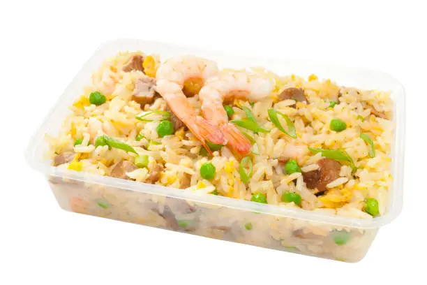 Plastic container filled with Chinese food, special fried rice or Yangchow fried rice, made with barbecue pork, shrimp or prawn, onions and peas, stir fried with egg and rice. Isolated on white, clipping path included.