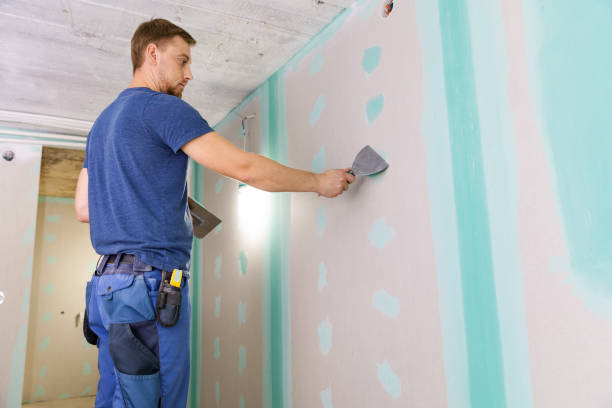 istock apartment interior construction - worker plastering gypsum board wall 1032486862