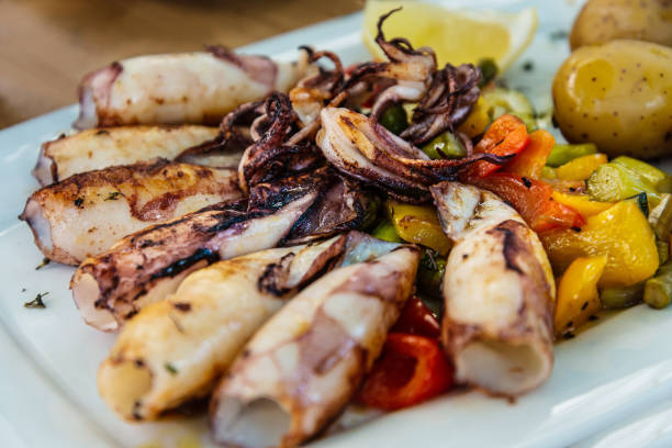 istock Mediterranean Octopus with vegetables and potatoes 1032489588