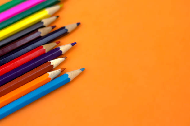 istock Colorful Pencils In A Row Over Orange Background 1032490024